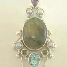 Artisan-crafted 925 sterling silver medallion pendant featuring a central oval labradorite cabochon, set with amethysts, blue topaz, peridots, and pearls in an ornate granulated Balinese frame.
