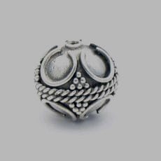 Handcrafted 925 sterling silver spherical bead decorated with traditional Balinese granulation dots, braided rope trim, and horseshoe scrollwork set against an oxidized silver background.