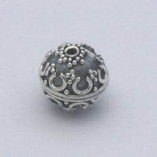 Artisan-crafted 925 sterling silver spherical globe bead featuring intricate Balinese granulation and horseshoe scrollwork with oxidized detail on a plain background.