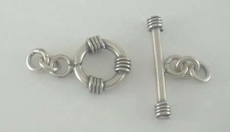 Artisan-crafted 925 sterling silver toggle clasp set featuring a round ring with coiled wire details and a matching T-bar closure with ring connectors on a plain background.