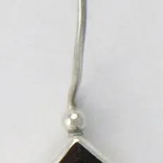 Close-up view of a handcrafted 925 sterling silver drop earring featuring a square faceted deep red garnet set in a geometric bezel on a sleek curved French wire hook.