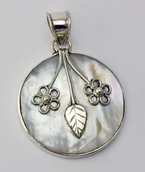 Front view of a handcrafted 925 sterling silver circular pendant featuring an iridescent Mother of Pearl shell disc decorated with silver flower stems, an etched leaf motif, and a polished bail.