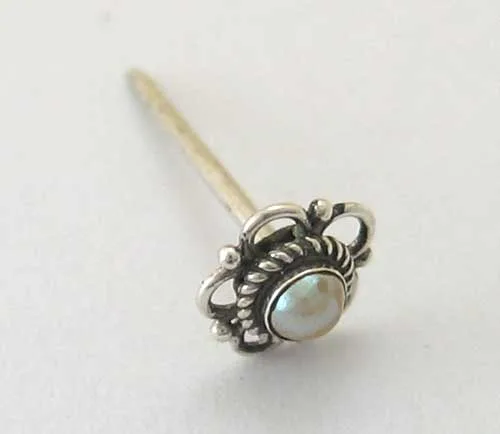 Side angle view of an artisan 925 sterling silver floral post stud showcasing a bezel-set mother-of-pearl stone with Balinese openwork wirework and granulation.