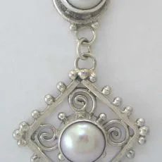 Handcrafted 925 sterling silver dangle earring featuring round pearl cabochons, openwork diamond frame, spiral wire scrollwork, and granulated bead borders.