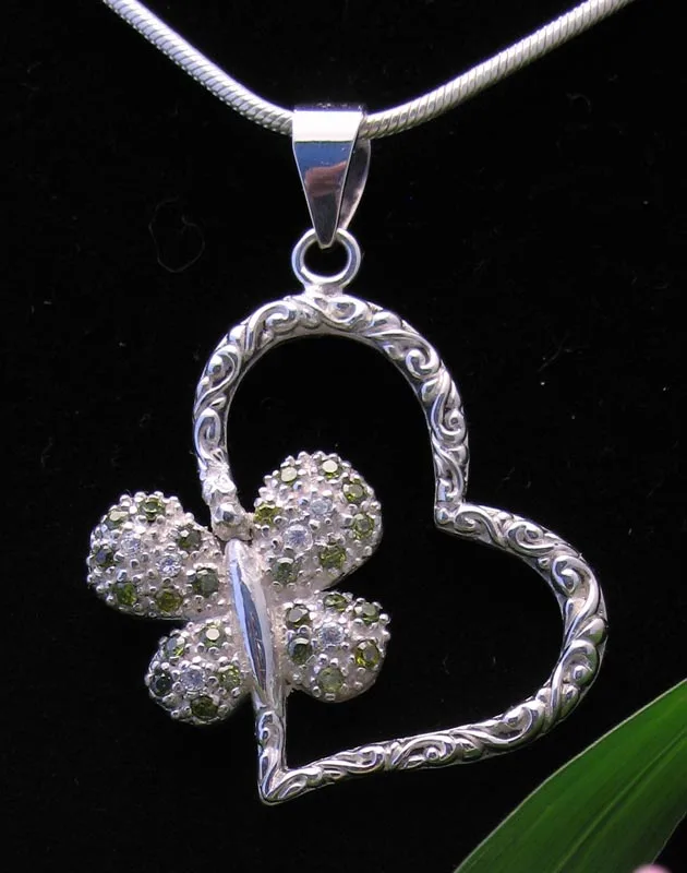 Handcrafted 925 sterling silver openwork heart pendant featuring Balinese scrollwork engraving and a pave-set peridot and clear gemstone butterfly accent.