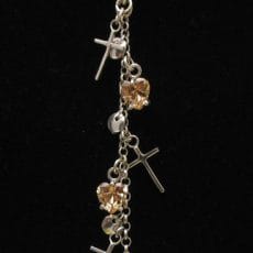 Artisan-crafted 925 sterling silver lariat-style drop pendant featuring a cascading chain with tiny silver crosses, polished round discs, and prong-set heart-shaped champagne cubic zirconia gemstones.