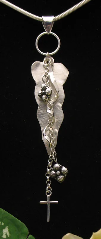 Front view of a Balinese artisan 925 sterling silver leaf pendant with cascading floral chain drop and dangling cross charm.