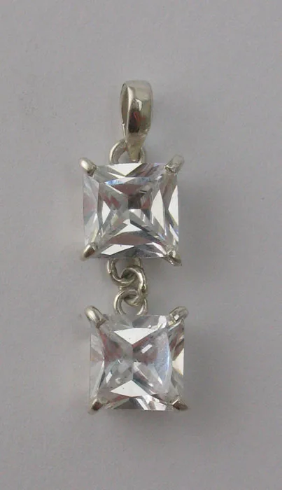 Front view of an artisan 925 sterling silver drop pendant featuring two princess-cut clear cubic zirconia gemstones in four-prong settings.