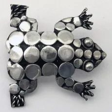 Artisan-crafted 925 sterling silver frog brooch featuring a detailed mosaic of polished silver disks and a deeply oxidized contrast background.