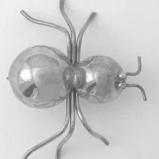 An artisan-crafted 925 sterling silver spider brooch featuring a highly polished, two-part rounded body with curved hand-forged silver wire legs.