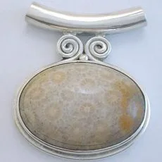 Artisan-crafted 925 sterling silver slide pendant featuring a large oval fossilized coral cabochon with twin wire spirals and a horizontal tube bail.