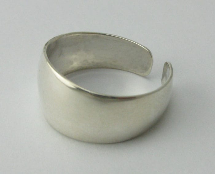 Artisan-crafted 925 sterling silver open band ring with a wide polished face on a plain background.