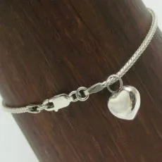 A detailed view of a sterling silver heart charm bracelet showcasing the secure lobster claw lock mechanism and the fine intricate weave of the chain.