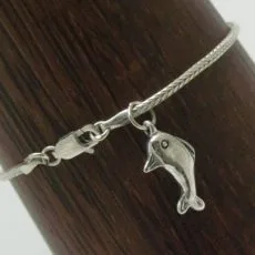 An artisan-crafted 925 sterling silver woven Borobudur chain bracelet displaying a polished dolphin pendant charm alongside its integrated lobster claw clasp.
