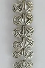 Handcrafted 925 sterling silver long drop earring featuring an oval rainbow moonstone cabochon framed by granulated silver beads and a cascading chain of articulated wire spirals.