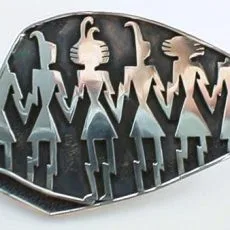 Artisan-crafted 925 sterling silver brooch featuring a detailed row of stylized tribal figures set against a heavily oxidized dark silver background.