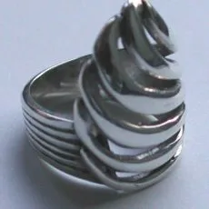 Artisan-crafted 925 sterling silver statement ring with a sculptural, multi-tiered ribbon wave spiral design and a high-shine polished finish, shown from a three-quarter side angle.