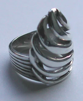 Artisan-crafted 925 sterling silver statement ring with a sculptural, multi-tiered ribbon wave spiral design and a high-shine polished finish, shown from a three-quarter side angle.