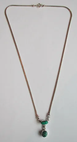 Full-length view of a handmade sterling silver snake chain necklace displaying a double turquoise gemstone drop pendant against a white background.