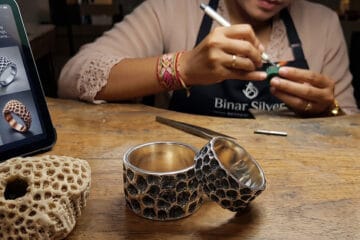 Bespoke 925 sterling silver matching couple rings with oxidized coral texture next to a natural coral stone and digital CAD sketch, handcrafted at Binar Silver factory in Denpasar Bali